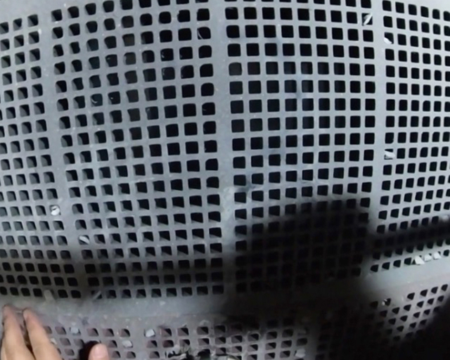 Inspection of Strudex rubber screen panel wear after three months in operation, showing minimal wear and tear on the screening area